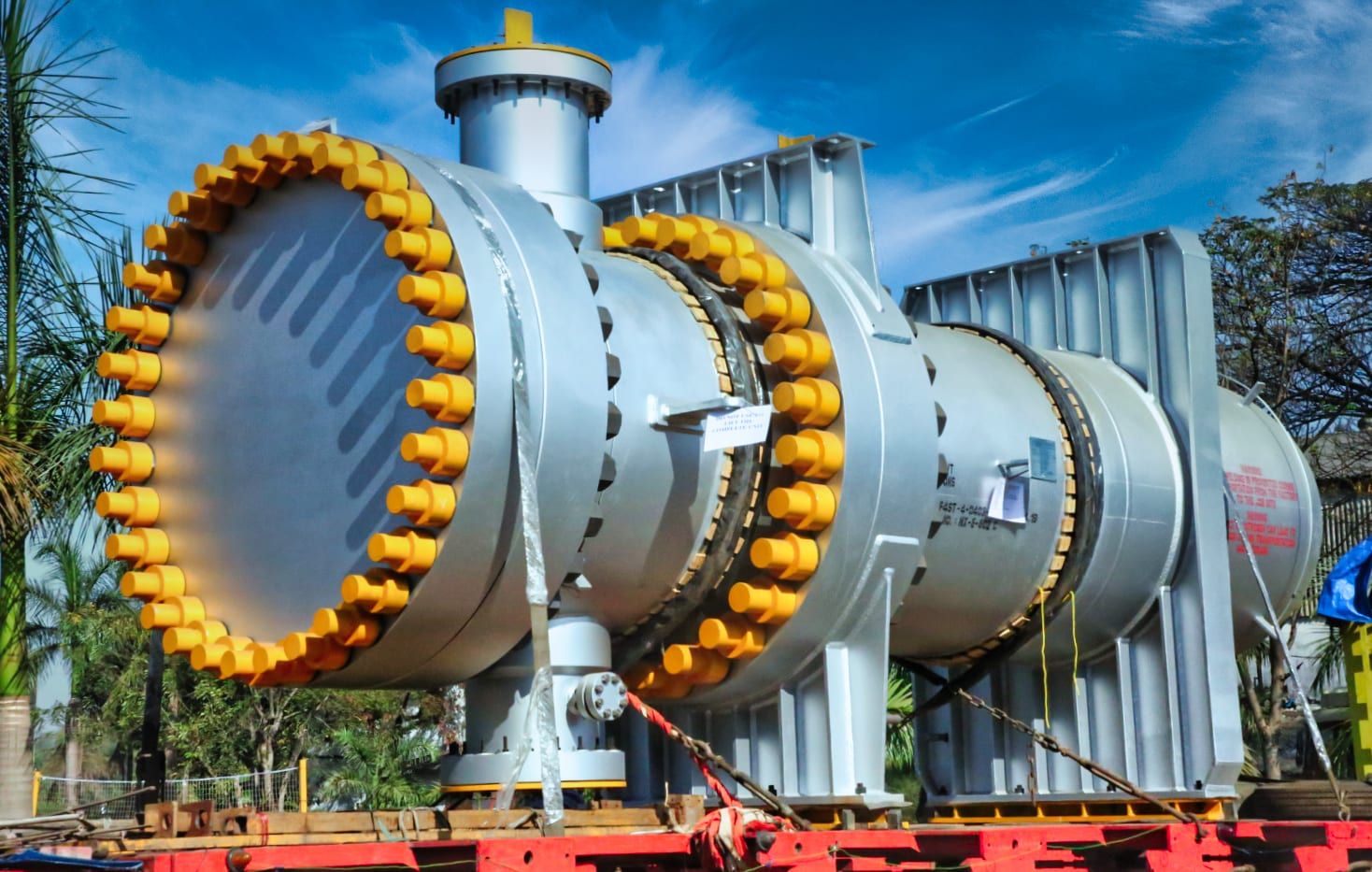 Shell and tube heat exchanger with yellow stud caps on its bolted closures